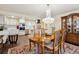 Dining room has decorative lighting, wooden table and chairs adjacent to the kitchen at 7255 E Quincy Ave # 404, Denver, CO 80237