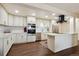 Bright kitchen features custom cabinetry, stainless appliances, and a center island at 7255 E Quincy Ave # 404, Denver, CO 80237