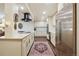 Spacious kitchen with stainless steel appliances, elegant cabinets, and decorative rug at 7255 E Quincy Ave # 404, Denver, CO 80237