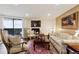 Cozy living room with fireplace, hardwood floors, and natural light at 7255 E Quincy Ave # 404, Denver, CO 80237