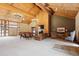 Inviting lobby area with wood beam architecture, elegant chandeliers, plush seating, and a cozy fireplace at 7255 E Quincy Ave # 404, Denver, CO 80237