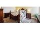 Well-lit primary bedroom featuring a four-poster bed and dark wood furniture at 7255 E Quincy Ave # 404, Denver, CO 80237