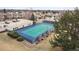 Aerial view of a well-maintained blue and green tennis court surrounded by trees and residential buildings at 7255 E Quincy Ave # 404, Denver, CO 80237