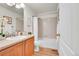 Bathroom with wood vanity, framed mirror, and shower-tub combo at 10149 W 55Th Dr # 101, Arvada, CO 80002