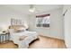 Bedroom with large window, ceiling fan, and hardwood floors at 10149 W 55Th Dr # 101, Arvada, CO 80002