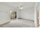 Bedroom with sliding glass doors leading to balcony and neutral carpet at 10149 W 55Th Dr # 101, Arvada, CO 80002
