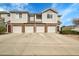 Well-maintained townhomes featuring brick accents, attached garages, and ample parking space for residents and guests at 10149 W 55Th Dr # 101, Arvada, CO 80002