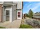 Inviting front entrance with gray siding, brick accents, and well-maintained landscaping, offering a warm welcome at 10149 W 55Th Dr # 101, Arvada, CO 80002