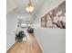 Entry hallway featuring hardwood floors, modern light fixture, and artwork on the wall at 10149 W 55Th Dr # 101, Arvada, CO 80002