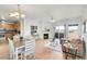 Open-concept living and dining area with a fireplace, light hardwood floors, and bright natural light at 10149 W 55Th Dr # 101, Arvada, CO 80002