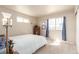 Simple bedroom featuring neutral carpet, a wooden dresser, and two windows allowing for lots of light at 12705 Ulster St, Thornton, CO 80602