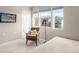 Cozy bedroom featuring a chair, bedside lamp, and bright windows offering a view of the neighborhood at 12705 Ulster St, Thornton, CO 80602