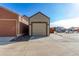 Exterior shot of a single-car garage with a concrete driveway and additional parking spaces at 12705 Ulster St, Thornton, CO 80602