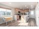 Well-lit kitchen featuring stainless steel appliances, ample countertop space, and a breakfast bar at 12705 Ulster St, Thornton, CO 80602