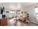 Bright and airy living room featuring hardwood floors, neutral paint and modern furnishings at 12705 Ulster St, Thornton, CO 80602