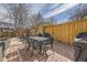 Cozy patio with dining area, barbecue grill, and string lights provides a perfect outdoor retreat at 1950 Kearney St, Denver, CO 80220