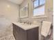 Elegant bathroom with double vanity, marble backsplash, and ample lighting at 1950 Kearney St, Denver, CO 80220