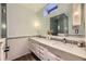 Bright bathroom offers double sinks, modern fixtures, a large mirror and tiled shower at 1950 Kearney St, Denver, CO 80220
