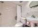 Bathroom features a clean shower/tub combo, white tiling, and a pedestal sink at 1950 Kearney St, Denver, CO 80220