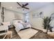 Charming bedroom boasts a decorative ceiling fan, plush rug, and ample natural light at 1950 Kearney St, Denver, CO 80220