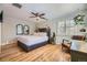 Stylish bedroom featuring hardwood floors, a ceiling fan, and a large window at 1950 Kearney St, Denver, CO 80220