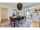 Dining room featuring a wooden table, chandelier, and stylish rug, perfect for Gathering dinners and gatherings at 1950 Kearney St, Denver, CO 80220