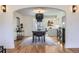 Spacious dining room with hardwood floors, chandelier lighting, and an open layout connecting to other living spaces at 1950 Kearney St, Denver, CO 80220
