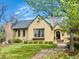 Charming home with a well-manicured lawn, brick walkway, and beautiful tree in a peaceful neighborhood at 1950 Kearney St, Denver, CO 80220