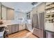 Modern kitchen featuring stainless steel appliances, white cabinetry, and ample counter space, perfect for cooking and entertaining at 1950 Kearney St, Denver, CO 80220