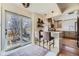 Eat-in kitchen featuring a breakfast bar, stainless appliances, and access to outdoor patio at 1950 Kearney St, Denver, CO 80220