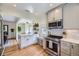 Bright kitchen with white cabinets, stainless steel appliances, and hardwood floors at 1950 Kearney St, Denver, CO 80220