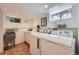 Functional laundry room with modern appliances, sink, and ample counter space at 1950 Kearney St, Denver, CO 80220