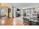 Elegant living room with hardwood floors, a brick fireplace, large windows, and plenty of natural light at 1950 Kearney St, Denver, CO 80220