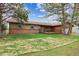 Well-maintained backyard with a deck and lush green lawn, framed by mature trees and blue skies at 8746 Sunridge Hollow Rd, Parker, CO 80134