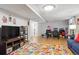 Basement with a large television, shelves, and a colorful rug creating a cozy entertainment space at 8746 Sunridge Hollow Rd, Parker, CO 80134