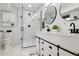 Modern bathroom with a glass shower, black hardware, and a vanity with double sinks at 8746 Sunridge Hollow Rd, Parker, CO 80134