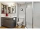 Bathroom featuring modern vanity with storage, a toilet, and a shower with a frosted glass door at 8746 Sunridge Hollow Rd, Parker, CO 80134