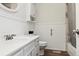 Clean bathroom with white wainscoting, shower, and plenty of natural light at 8746 Sunridge Hollow Rd, Parker, CO 80134