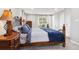 Comfortable bedroom with a wood bed frame, side table, and natural light from the window at 8746 Sunridge Hollow Rd, Parker, CO 80134