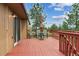 Outdoor deck with seating and a table under an umbrella, complemented by the home's exterior at 8746 Sunridge Hollow Rd, Parker, CO 80134