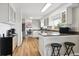 Bright kitchen with stainless steel appliances, breakfast bar, and wood-look flooring at 8746 Sunridge Hollow Rd, Parker, CO 80134