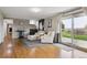 Cozy living room with two white chairs, dark cabinets, and sliding glass door at 8746 Sunridge Hollow Rd, Parker, CO 80134