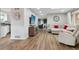 Open-concept living room with wood flooring, modern decor, and seamless flow to other areas at 8746 Sunridge Hollow Rd, Parker, CO 80134