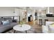 Cozy living room with a view of the kitchen, featuring comfortable seating and neutral decor at 8746 Sunridge Hollow Rd, Parker, CO 80134