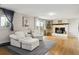 Comfortable living room with a decorative fireplace, white chairs, and a sliding glass door at 8746 Sunridge Hollow Rd, Parker, CO 80134