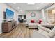 Spacious living room featuring wood floors, neutral decor, and modern entertainment setup at 8746 Sunridge Hollow Rd, Parker, CO 80134