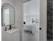 Bright bathroom with vanity, mirror, and view into bedroom at 1131 S Raleigh St, Denver, CO 80219