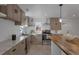 Modern kitchen with island, stainless steel appliances, and wood cabinets at 1131 S Raleigh St, Denver, CO 80219