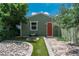 Quaint backyard garden area with a stone pathway and a charming birdbath feature at 616 W 1St Ave, Denver, CO 80223