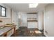 Unfinished basement features tile floor, white cabinetry, and a sunny window at 616 W 1St Ave, Denver, CO 80223